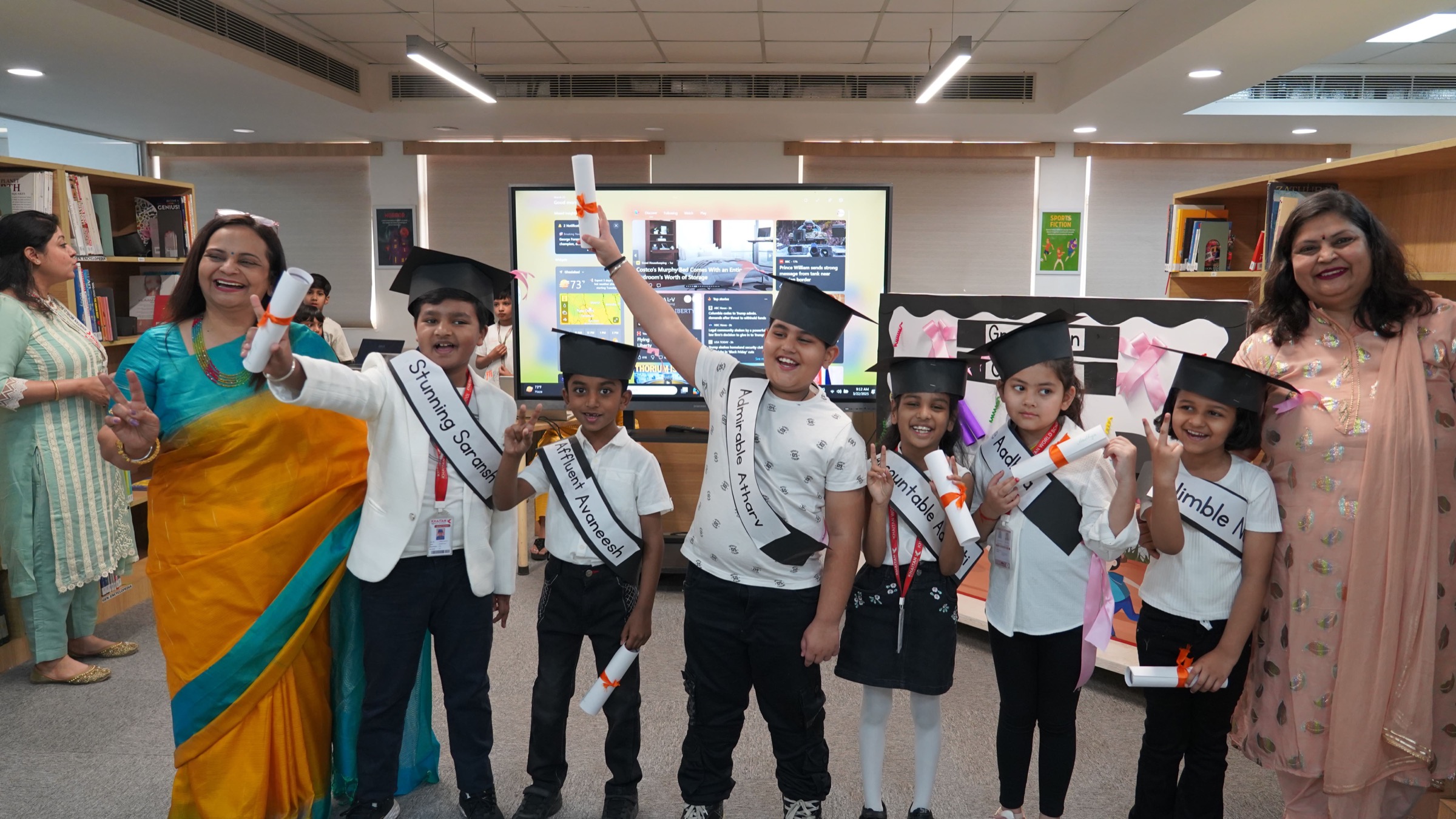 Khaitan World School students in graduation caps and sashes celebrating with their certificates