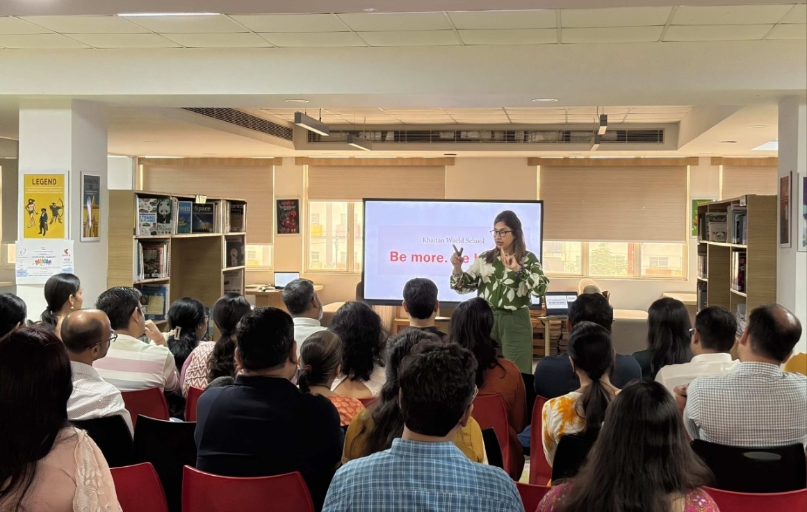 A Khaitan World School briefing for parents in the library, with a 'Be more. Be better.' slide on screen